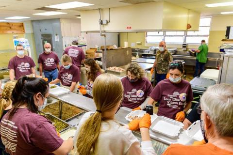 Volunteers put together Thanksgiving dinners during a recent event hosted by Love Him Love Them Ministries. 