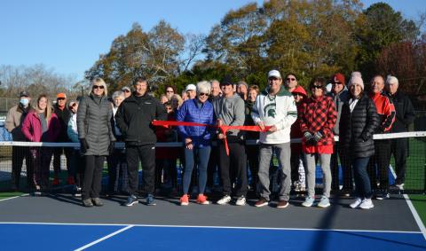 Sunshot by Michael Hall In the front row, Angie Putman, CEO of YMCA of Georgia’s Piedmont, Joby Scroggs, Henley Cleary, Eddie McCurley, Frank Gunder, Kathy McCurley and Bell Family YMCA director Mandy Floyd cut the ribbon on new outdoor pickleball courts at the YMCA with Lake Hartwell Pickleball Club members behind them