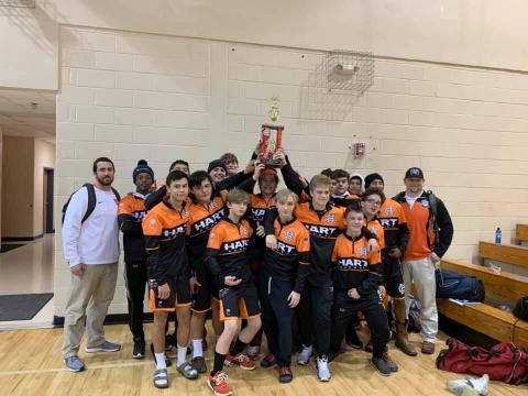 Photo submitted - The Hart County wrestling team holds up its first-place trophy after winning the “King of the Mountain” tournament on Dec. 5 in Towns County. 
