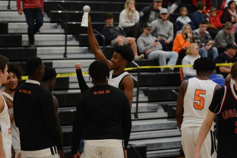 Sunshot by Grayson Williams - Hart County’s Tahj Johnson holds up the McDonald’s Shootout championship trophy at Hart County High School on Dec. 30. 