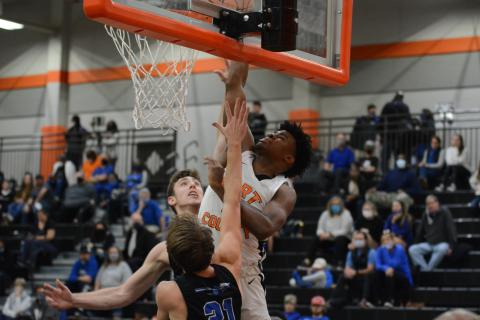 Sunshot by Grayson Williams - Hart County’s Tahj Johnson posterizes two Oconee County players by dunking on them Friday, Jan. 22, at Hart County High School. 