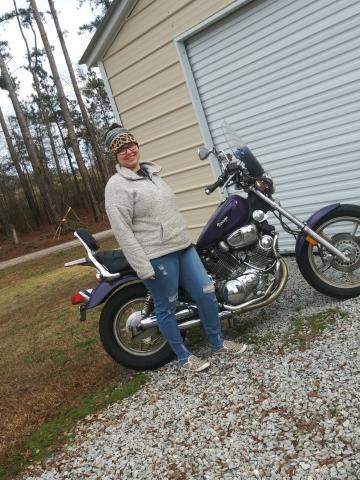 Brooke Dutton, event organizer for Women Ride, Women Build, poses with her bike.