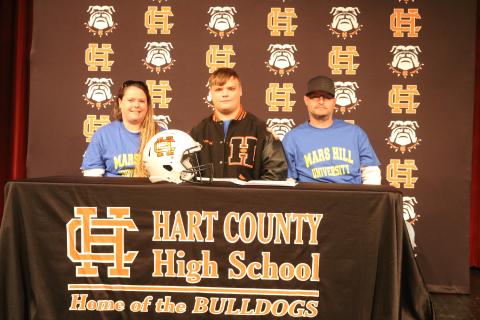 Sunshot by Grayson Williams Gabriel Coker, center, flanked by his mom, Amanda Morgan, and dad, Lee Morgan, signed last week to play college football at Mars Hill University.