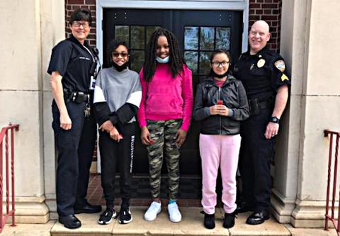 Pictured are officers Kay Ankerich, left, and Paul Agnew, right, with essay winners Chyna Orsley, from left to right in the middle, Audrey Harper and Sariyah Heard.