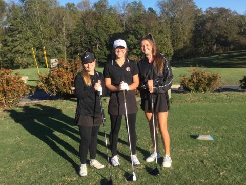 Mary Elizabeth Jackson, middle, stands with high school teammates Lauren Weaver, left, and Ella Franklin, right.