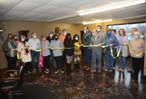 Owner Natasha Fields, pictured in the center with the scissors, is joined by her daughter Taryn Fields, to her left, fiance Daryl Denney, behind her, and her mother, Thelma Bowens, as well as members of the Hart County Chamber of Commerce board of directors, Mayor Brandon Johnson, councilman Tray Hicks, and members of Hartwell Main Street and the Downtown Development Authority. 