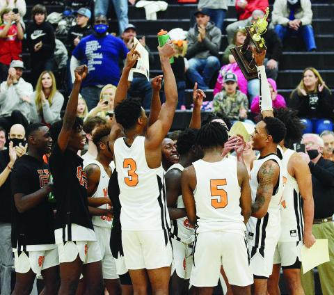Sunshot by Michael Hall - Hart County senior Shone Webb, right, holds up the Region 8-AAA trophy on Saturday, Feb. 20, at Hart County High School after the Bulldogs defeated Monroe Area 61-52 to claim the school’s first boys’ basketball region championship since 2008. 