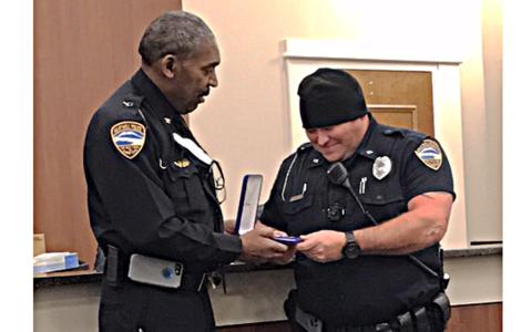 Hart County police chief Anthony Davis, left, presents officer Matthew Dutton with the department's Medal of Valor recently. 