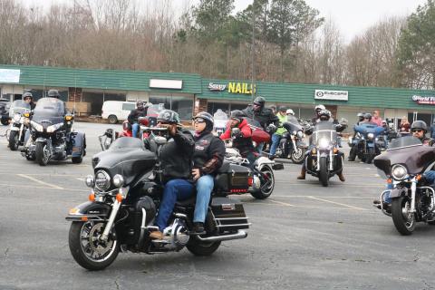 Motorcyclists leave the parking lot of the Quality Foods parking lot on Saturday, Feb. 27, for the Women Ride, Women Build motorcycle ride.