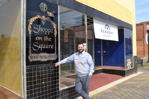 Sunshot by Drew Dotson - Major Harris poses outside the old Shoppe on the Square building in downtown Hartwell that now houses his Farmers Insurance agency. 