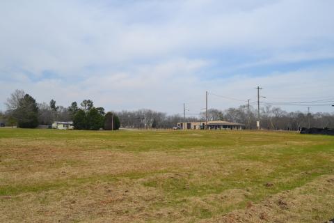 Sunshot by Drew Dotson - The now empty lot at 55 Ridge Road is shown where a house once sat with the old Ed Murdock dealership in the background across the street. 