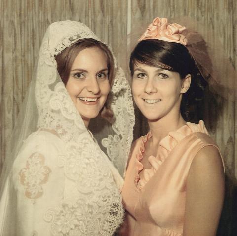 Bride Pam Shirah shares a smile with her maid of honor, Judy Mizell, on Aug. 23, 1969. Today, Pam S. NeSmith and Judy M. Wolbe celebrate a collective 102 years of marriage to the men they dated in college.