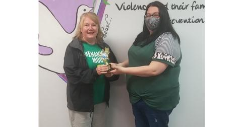 Photo submitted Sharon Swint, left, accepts a trophy recently from the Northeast Georgia Council on Domestic Violence representative Kayla Wilson for taking the Polar Bear Plunge for 25-straight years.