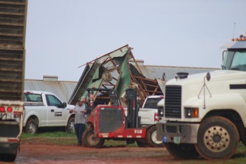 Sunshot by Grayson Williams - A pile of wood, metal and other materials shown is all that is left of a chicken house at a Woodland Way farm as workers clear the damage from a series of storms that swept through Hart County on March 25 and 26.