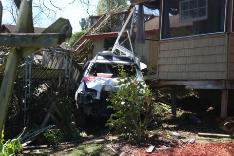 Sunshot by Grayson Williams - A car that went through a power pole and multiple fences before crashing into the rear of a residence on Royston Highway is pictured.