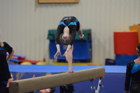 Sunshot by Grayson Williams Bella Beck bends backwards during her beam routine at the Bell Family YMCA on Friday, April 16.