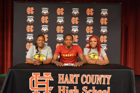 Sunshot by Drew Dotson - Shone “Spudd” Webb, middle,  signed to play collegiate basketball next to his  mom Shelle Smith, left  and his sister Tyia Webb, right.