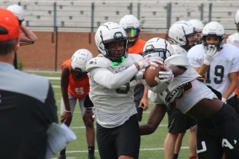 Sunshot by Grayson Williams Rising senior Malachi Kelley hauls in a pass and fights off a defender in a drill during the first day of spring practice at Herndon Stadium on Monday, May 17.
