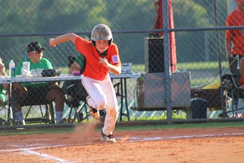 Sunshot from file - In a 2018 Little League All-Star tournament game, Kanyon Coulter sprints to first base after smacking a hit in the District 7 tournament where the Bulldogs earned first place.