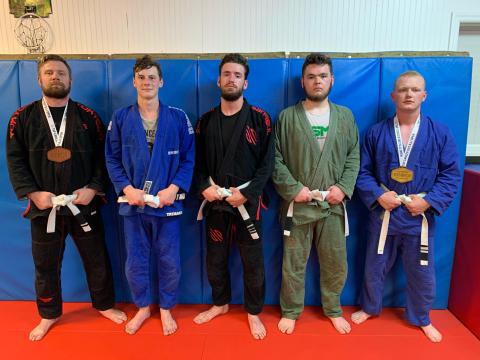 Photo submitted - Local jiu jitsu fighters, pictured from left to right, Chris Burns, Luke Didier, Jared Carswell, Chandler Howell and Alex Maxwell, all competed at and raised money for the Tap Cancer Out Brazilian Jiu Jitsu tournament on May 22 in Atlanta.