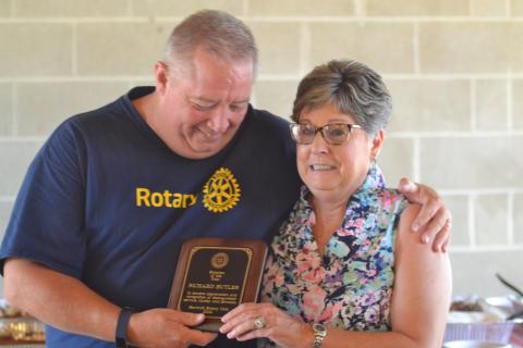Dan Hunt/The Hartwell Sun - Rotary president Mike Everett hands Nancy Butler the Rotarian-of-the-Year Award. Butler was in attendance to accept the award on behalf of her late husband Dick, the most recent past president, who died June 1.