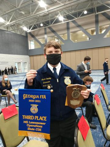Conner Bentley displays his awards at the Georgia State FFA Lawnmower Operation and Maintenance Career Development Event. 