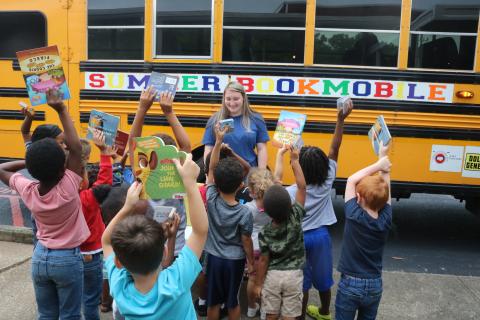 Grayson Williams/The Hartwell Sun - A crowd of students line up at Hart County Headstart on Richardson Street on June 8 to receive free books from the annual Summer Bookmobile put on by Hart Partners.