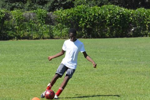 Naim Durham shoots for the goal at the YMCA soccer camp.
