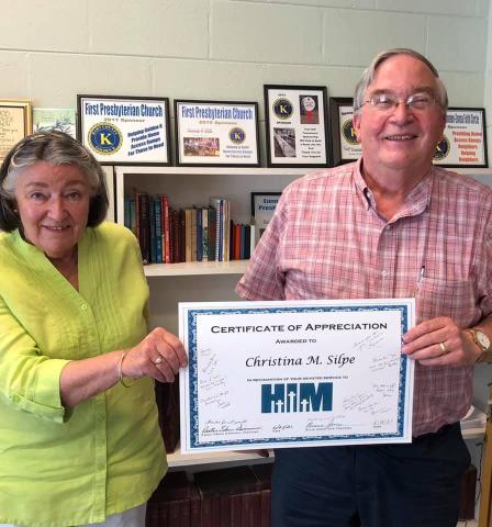 Christina Silpe, left, is handed a certificate of appreciation by Reverend Edwin Simmons for her years of service to Hart Interdenominational Ministry.