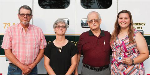 Josh Brannen/The Hartwell Sun - Russell Cooper (far left), Brandi Cooper (center left), Randall Dean Graham (center right), and Morgan Cooper (far right), all EMT’s, stand in front of an ambulance.