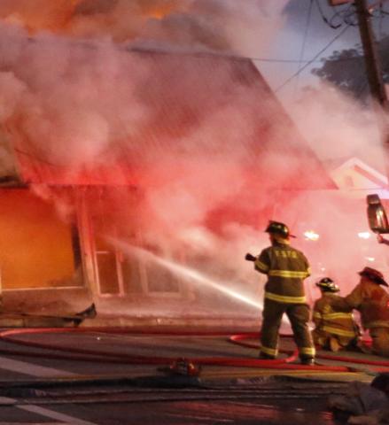 Firefighters work to extinguish a fire Tuesday in the former Royce Theatre building in downtown Royston. The building was being used for storage at the time of the fire, which was contained to just that building. 