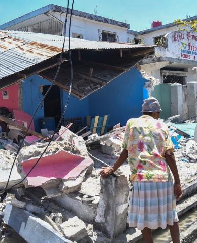 A Haitain woman surveys damage to her home after Saturday's earthquake.