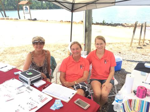 Marilyn Bowman, left, Pamela McGovern, center, and Kristine Freeland, right, smile for the camera as they deal poker hands in support of Hart County Humane Society.