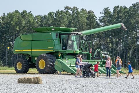 Visitors convene in front of one of the many examples of heavy machinery at this weekend’s Ag Expo.