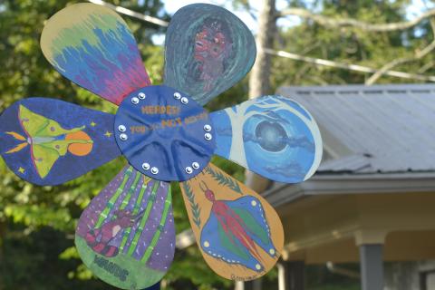 The five-foot tall sculpture features painting work from seven artists, including unique designs on each of the daisy’s six petals.