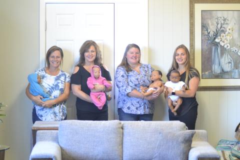 From left to right, Mindy Wise, Tammy Fyre, Barbara Stowe and Claire Beggs display the new dolls at Hart Life will be used as part of the Earn While You Learn program.