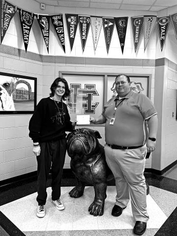 Principal Kevin Gaines presents student Ethan McDowell with his commended student designation.