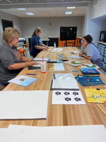 Oglesby and her team of StoryWalk creaters hard at work creating books for Hart County. 