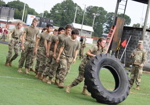 The Hart County JROTC competes in the tire flip.