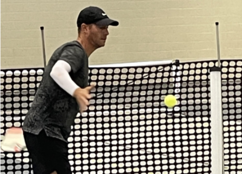 Pickleball pro Mark Price helps students with their technique at the YMCA in Hartwell.