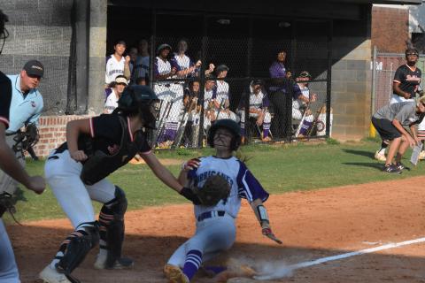 Marlee Harris tags  Monroe Area base-runner out at home on Sept. 10.