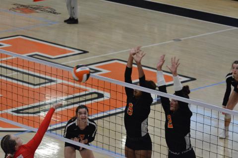 Alexis Walker (9) and Lille Kate Rogers (2) block the Madison attack as Aliza Hart (3) waits to make a play.