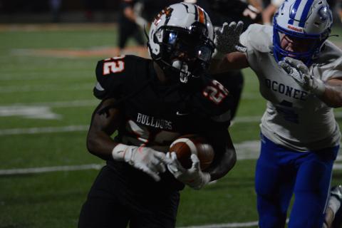 An Oconee defender closes in on running back Nori Moore after a sizable gain on a screen pass.