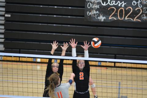 Cali Beebe (left) and Lillie Rogers (right) go up for a block in their last home match on Sept. 23.