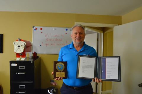 Tim Strickland proudly displays his award for 31 years of service and his award for driving a million miles or 30 yea without a preventable accident. 