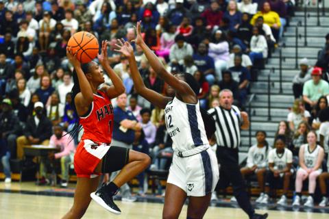 Valasha Carter shoots over the outstretched hands of an Elbert County defender on Dec. 3.