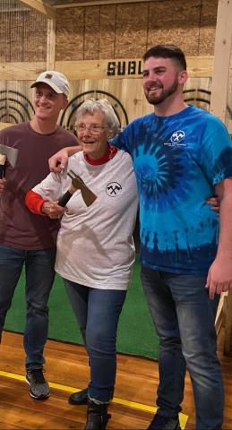  Maxine Davis (center) smiles after making her axe throwing debut at Sublime Axe Throwing. 