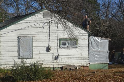 Contractors renovate a roof at 150 Rome Street on Monday, Dec. 13 as part of Habitat for Humanity’s plan to renovate homes in Rome and Richardson.  