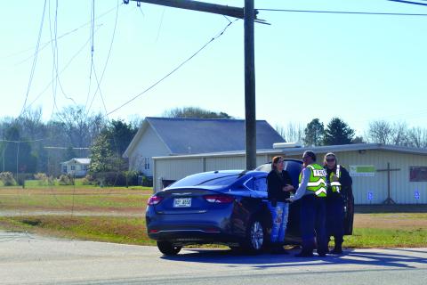 Officers talk to a driver after a wreck that took down a power line along Royston Highway, 