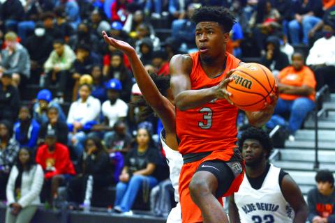 Tahj Johnson flies through the Elbert County defense in their 58-42 victory in front of a packed house on Friday, Dec. 3.